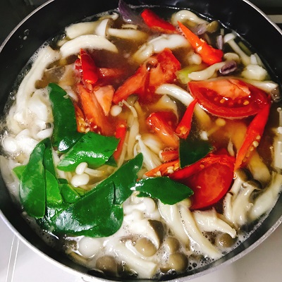 ハーブを足して煮込むトムヤム
